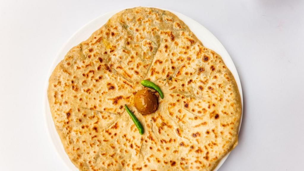 Aloo Paratha · Pan cooked whole wheat bread stuffed with spiced potatoes and herbs.