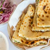 Paneer Paratha · Pan cooked whole wheat bread stuffed with homemade cheese, onions and spices.