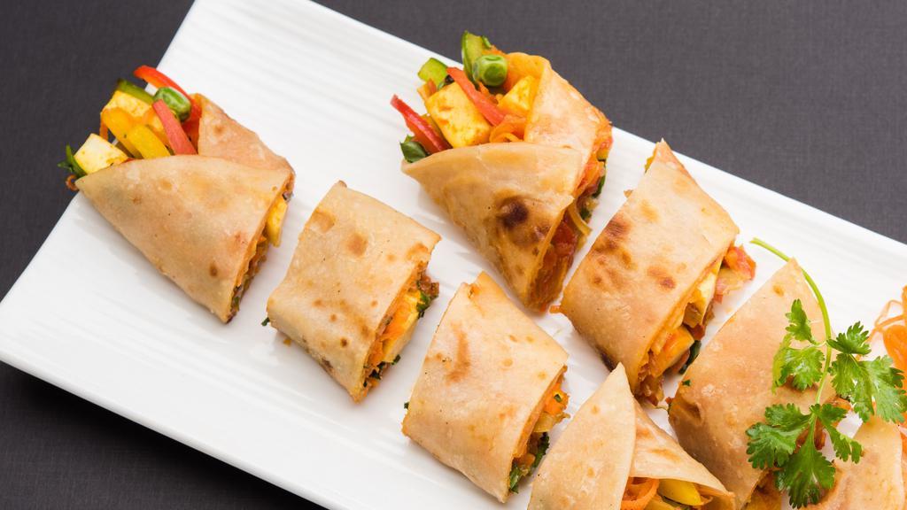 Chili Paneer Wrap · Chili paneer wrapped in plain paratha or spinach paratha served with chaas or soda.