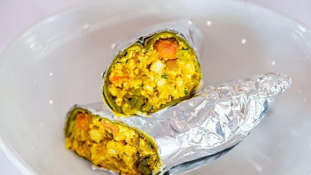 Paneer Bhurji Wrap · Mashed homemade cheese cooked with spices, wrapped in plain paratha or spinach paratha, served with chaas or soda.