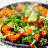 Tandoori Paneer Tikka · Home-made cheese and vegetables with herbs and spices, cooked in a clay oven.