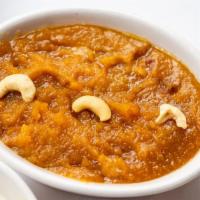 Moong Dal Halwa · Yellow lentil pudding mixed with nuts and dry fruits.