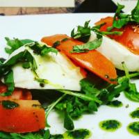 Caprese  · Vegetarian. Fresh Italian imported cow-milk mozzarella cheese and tomatoes, topped with home...