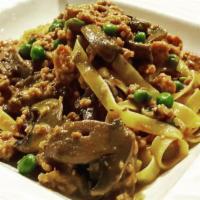 Fettuccine Alla Boscaiola  · Fresh homemade fettuccine pasta with mushrooms, ground Calabrian mild pork sausage, peas, to...