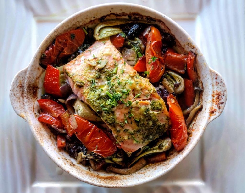 Salmon en cocotte · Fresh  salmon fillet, baked in casserole with shimeji mushroom , baby bok choy, red bell pepper, red onion , black Gaeta olives, basil pesto (nuts free, with Parmesan) and tomato confit