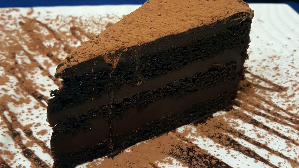 Torta al Cioccolato / Chocolate Cake · Traditional Italian layer chocolate cake, filled with a rich chocolate cream, covered with chocolate ganache and rimmed with chocolate flakes.