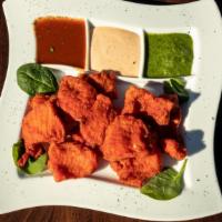 Fish Pakora · Golden-fried crispy and spicy Swai fish in a special marinade flavored with fenugreek.