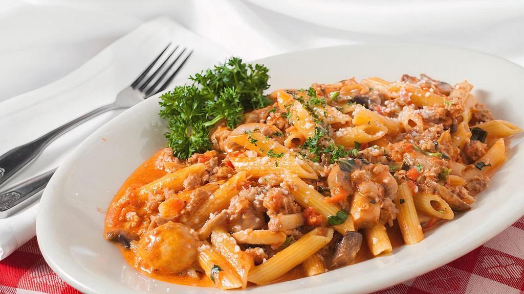 Penne Calabrese · Our family made Italian sausage and fresh mushrooms in a light tomato cream sauce tossed with penne pasta.