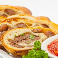 Sausage Bread · Slices of our own family made Italian sausage and mozzarella baked in our homemade dough. Se...