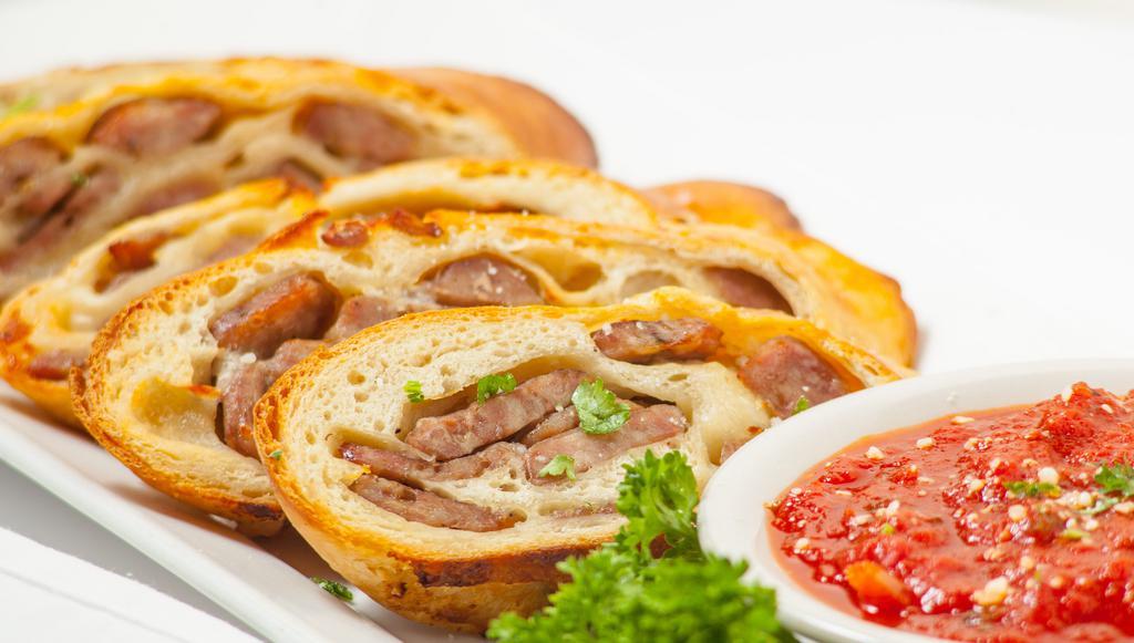 Sausage Bread · Slices of our own family made Italian sausage and mozzarella baked in our homemade dough. Served with marinara sauce