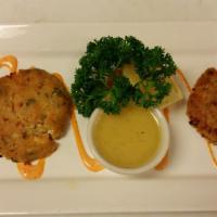 Crab Cakes · Handmade Dungeness crab cakes, grilled and served with a lemon butter sauce.