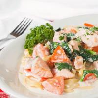 Fresh Salmon Florentine · Salmon sautéed with garlic, butter, shallots, fresh tomatoes & spinach in a creamy Alfredo s...