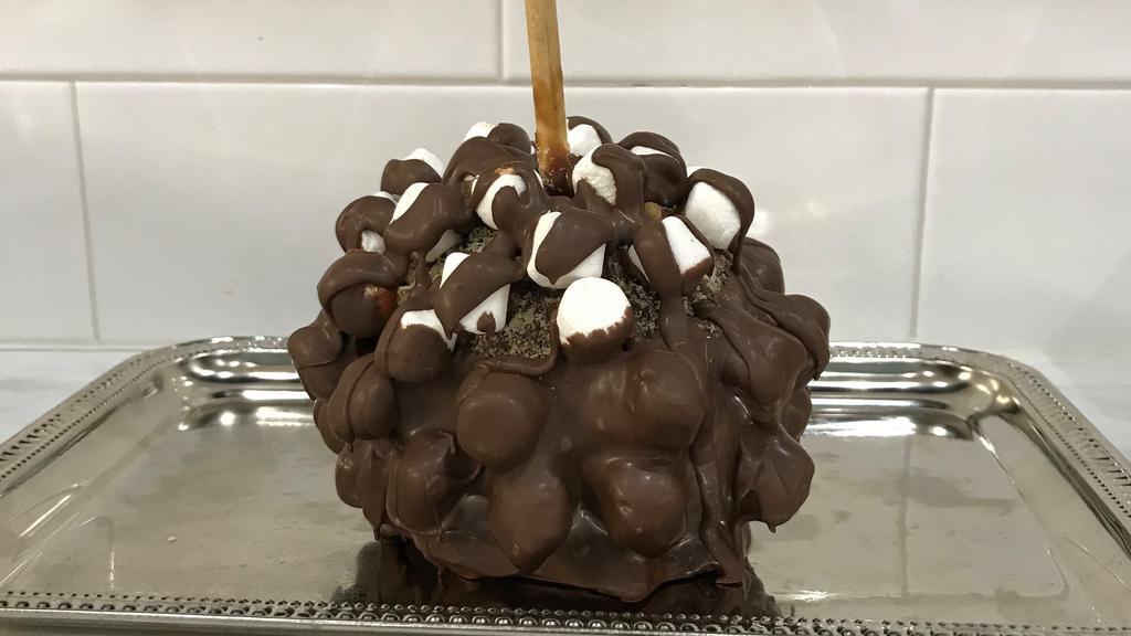 Rocky Road Caramel Apple · Largest Apple you can imagine.  Granny Smith apple dipped in rich homemade caramel , rolled with pecan and mini marshmallows and drizzled with  Belgian chocolate.