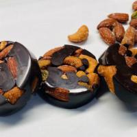 Dark Chocolate Nut  Disc ( 3 piece) · Handmade with Dark chocolate and gazed nuts ( Almonds, Cashews, Pistachios and Pecan) 3 disc...