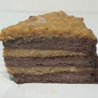 German Chocolate cake · German chocolate cake layered and topped with coconut and pecan glaze.