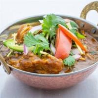 Traditional Chicken Curry · Chicken cooked in tomato and onion sauce with cumin and coriander.