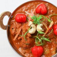 Lamb Achari-Premium · Pieces of tender lamb cooked with lemon, indian herbs and mixed pickle in an aromatic spicy ...