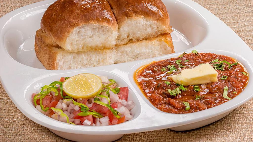 PAV BHAAJI (AMUL CHEESE)* · Spiced mixture of mashed vegetables in a thick gravy topped with grated Amul Cheese and served with a pair of butter bread bun (pav). Served with Onion and lemon