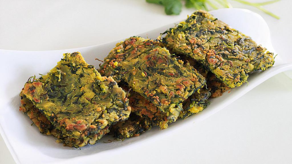 KOTHIMBIR VADI(6 PCS)* · Delicious savory fritters made with gram flour (besan), cilantro and spices. In marathi language “kothimbir” stands for cilantro and 'vadi' means slices or wedges.
