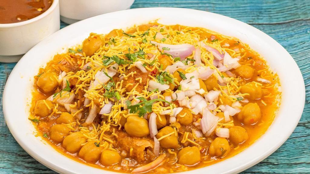 SAMOSA CHAAT* · Tangy and spicy Samosa Chaat is popular north Indian street food. Crunchy samosa is served with spicy chickpea curry (chole), yogurt and chutneys.