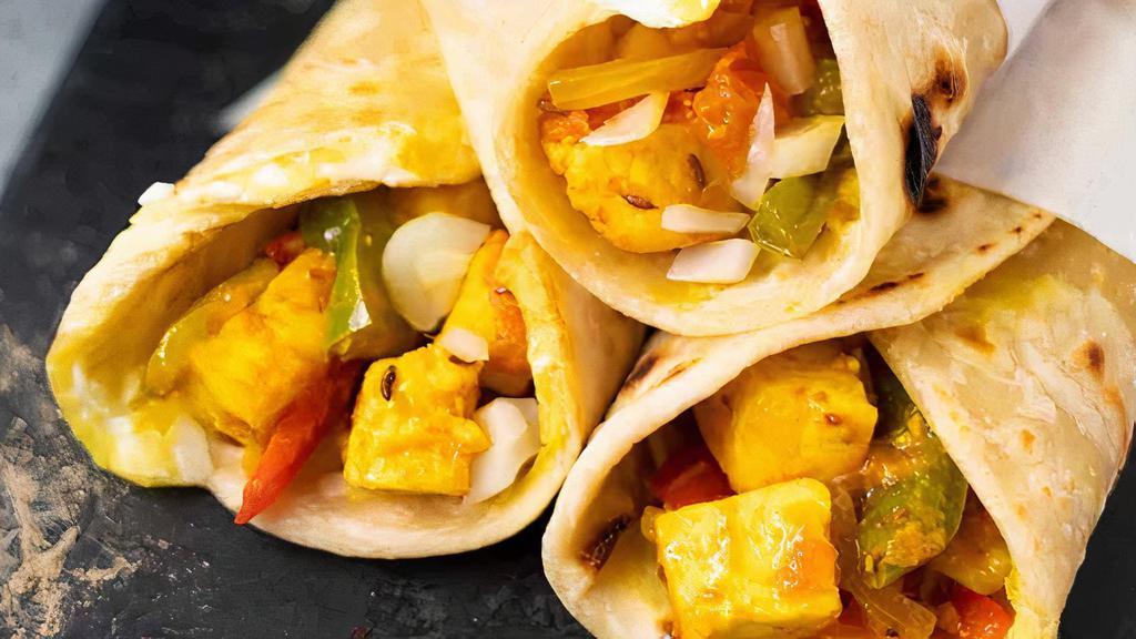 PANEER KATHI ROLL* · Paneer Kathi Roll is made with flatbread, stuffed with paneer (Indian Cottage Cheese) that has been marinated in indian herbs and spices, as well as onions, topped with savory chutney.