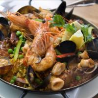 Paella Clasica · Mussels, chicken, clams, scallops, gambas, calamari, pork chorizo, bell peppers, and english...