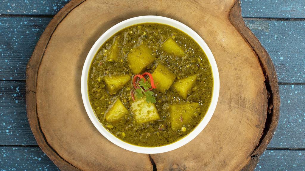 Saag aloo loo land · Slow-cooked spinach and mustard greens with fresh ginger, aloo and garlic. Vegan.