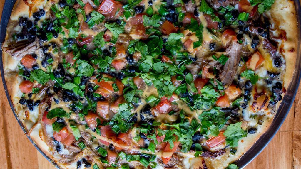 El Presidente · Garlic sauce, carnitas, black beans, tomatoes, green onions, finished with cilantro and orange sauce.