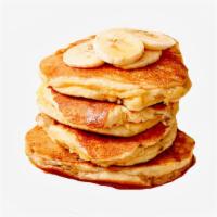 Banana B*tches Pancakes · Two fluffy pancakes with bananas  served with a side of butter and syrup.