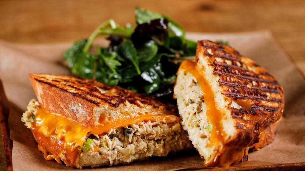 Tuna Melt Sandwich · Mediterranean style albacore tuna with capers, lemon, onions, extra-virgin olive oil, parsley, melted aged sharp cheddar cheese, grilled country levain