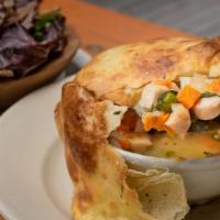 The Grove's Chicken Pot Pie · house brined roast chicken breast in a rich chicken broth, carrots, peas, topped with a roll...