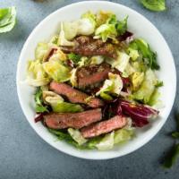 Caesar Steak Salad · Fresh Caesar Salad prepared with marinated steak strips, romaine lettuce, shredded cheese, t...