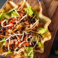 Crispy Taco Salad · Delicious crispy taco salad prepared with fresh romaine lettuce topped with black beans, shr...