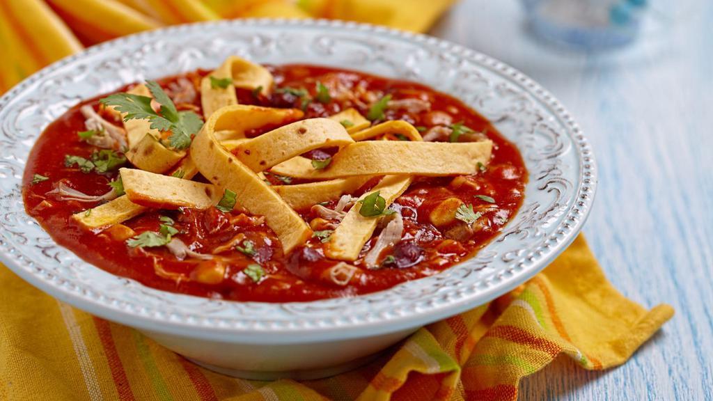 Tortilla Soup · Hot & Tasty Soup filled with Marinated grilled chicken, fresh avocado, cheese and tortillas strips.