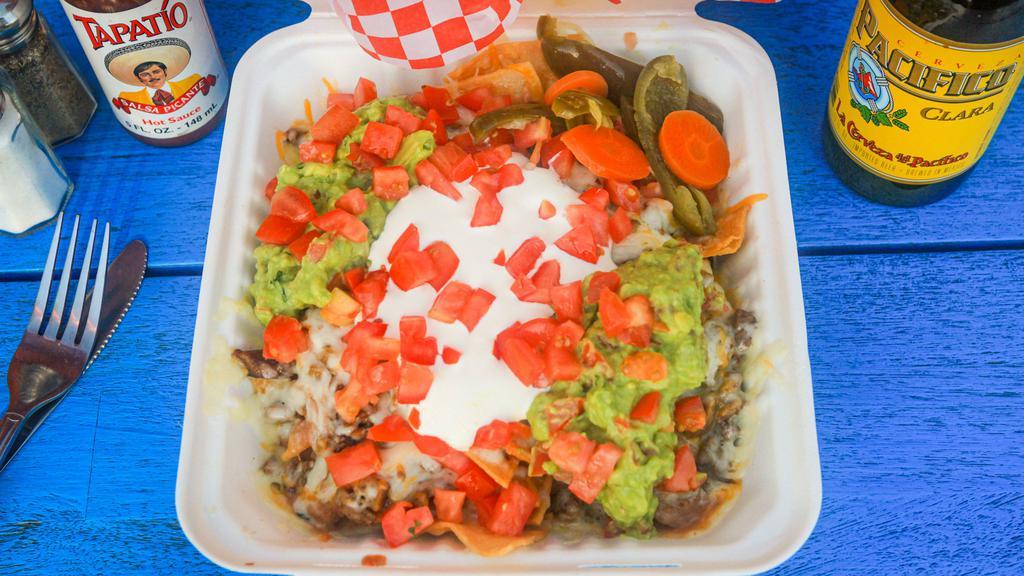 Nachos · Chips, beans, meat, cheese, guacamole, tomatoes, sour cream and jalapenos.
choose one;
vegetarian
grilled vegetables
steak
grilled chicken
shredded chicken
al pastor
carnitas
ground beef
chorizo