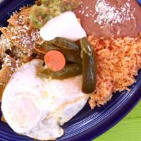 Chilaquiles · Crispy corn tortillas with two scramble eggs and a special red or green sauce, topped with M...