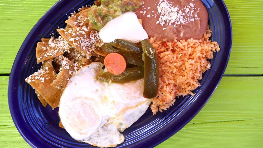 Chilaquiles · Crispy corn tortillas with two scramble eggs and a special red or green sauce, topped with Mexican cheese.