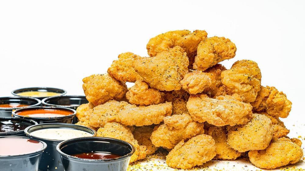 32 Bites · 32 pieces of oven baked crispy chicken bites seasoned with your choice of dust and served with your choice of 8 dips.
