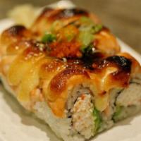Lion king Roll · Avocado, Imitation Crab and Cucumber inside, Topped with Salmon, Cream Cheese and Seared The...