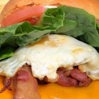 Humpty · Breakfast sandwich. Two fried eggs,  two slices of bacon, and one slice of cheddar, some gri...
