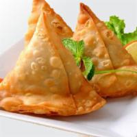 Samosa · Freshly prepared deep-fried pastry filled with mashed potatoes and served with tamarind and ...