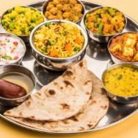 The Thakali Thali Veg · Freshly prepared thali served with saag, kalo dal, the vegetable of the day, rice and achar.