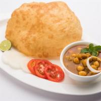 The Chole Bhature · Freshly prepared Punjabi style chole, served with a side of warm naan.