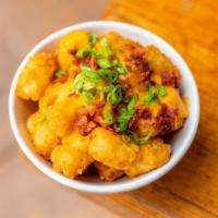 Buffalo Tots · Crispy fried tater tots served with a side of our house made buffalo sauce topped with blue ...