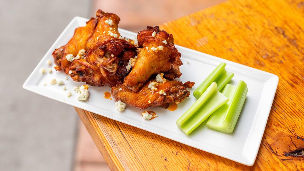 Jumbo Buffalo Wings · Signature house brined chicken wings served with a side of our house made buffalo sauce topped with blue cheese crumbles