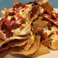 Loaded Nachos · Choice of meat, chips, refried beans, cheese, sour cream, guacamole, onions, cilantro, mild ...
