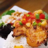 Cajun Fish · Topped with mango salsa, rice and salad on the side.