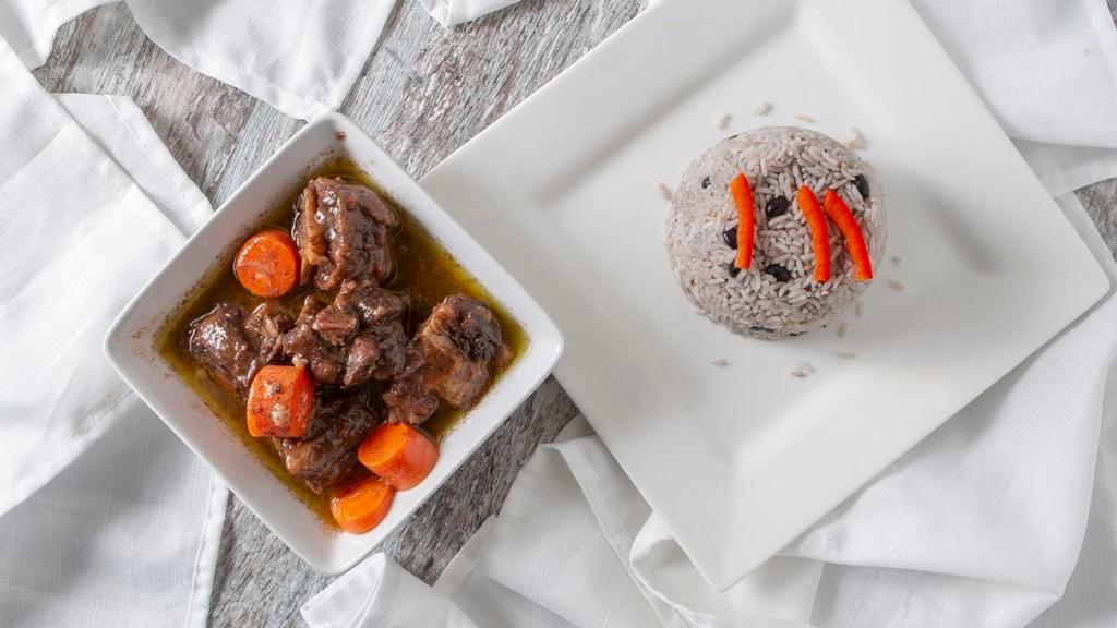 Oxtail Served with Rice & Bean · Oxtail stew with white rice mixed with red beans.