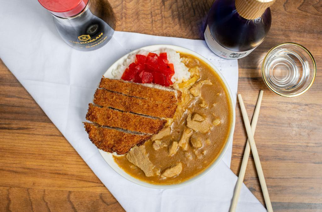 JAPANESE KATSU CURRY RICE · - Pork cutlet Japanese Curry over rice served with red pickles.