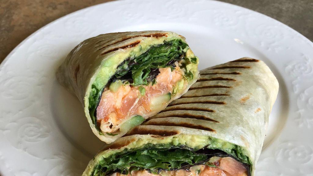 Sweet Chili Salmon Avocado Wrap · Fresh Salmon marinated in a mix of spicy garlic chili and sweet teriyaki sauce with mixed greens, avocado, sprouts, cucumber and chipotle aioli in grilled tortilla.